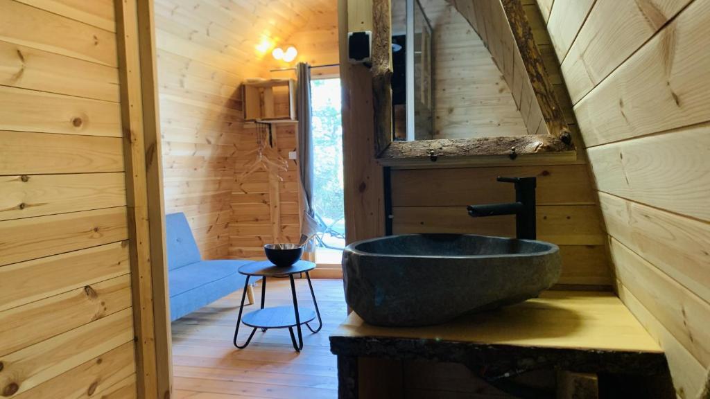 un bagno con lavandino in una baita di tronchi di Camping les Hauts de Rosans a Rosans