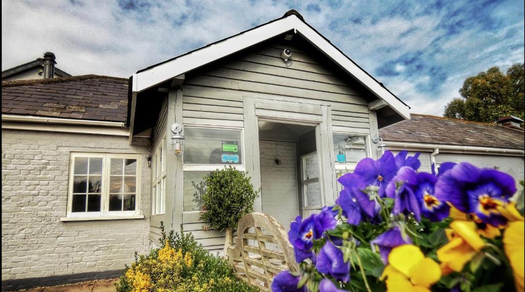 a house with purple flowers in front of it at Blazing Donkey Country Hotel in Sandwich