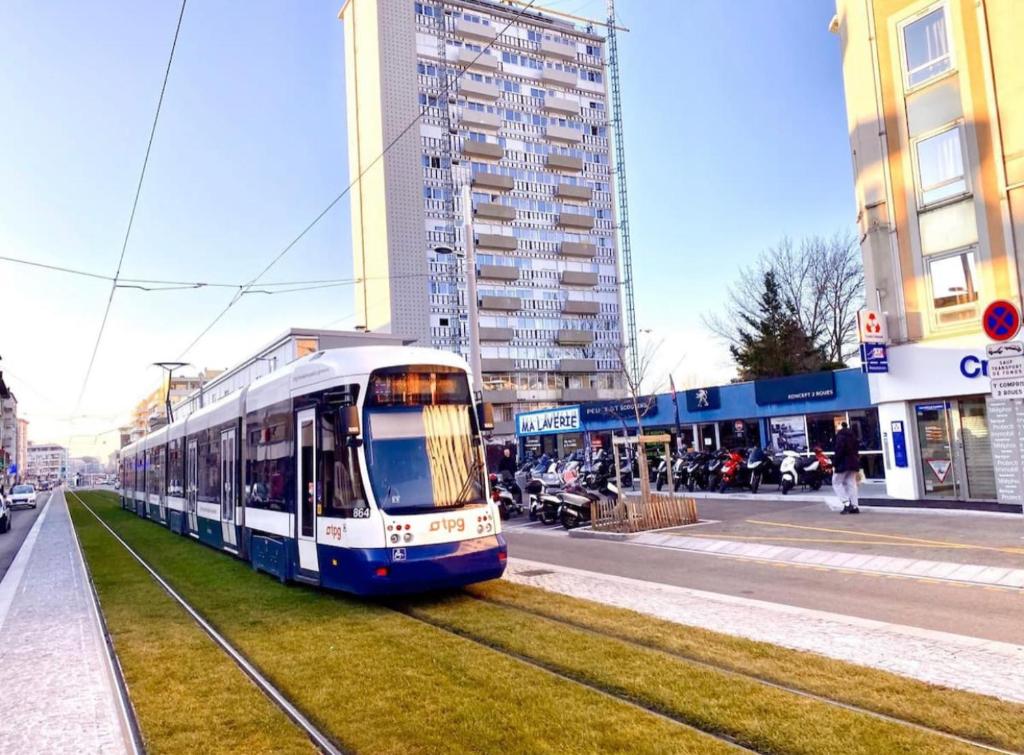 a tram is on the tracks in a city at Villa du Centre in Annemasse