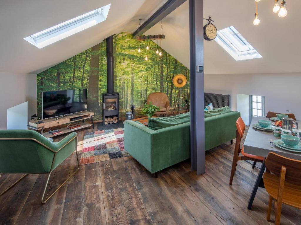 a living room with green furniture and a fireplace at 2 Bed in High Bickington 49558 in High Bickington