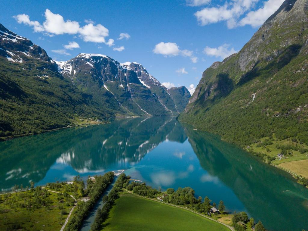 an aerial view of a lake between two mountains at Olden Glamping - One with nature in Stryn