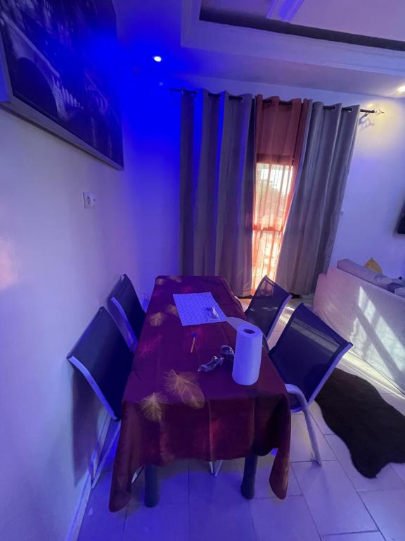 a dining room with a table and chairs and a window at Grand Yoff in Ziguinchor