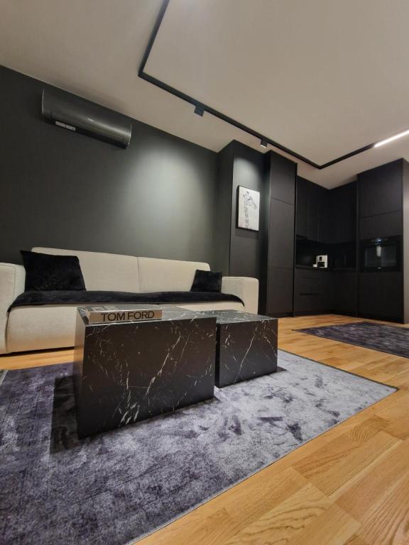 a living room with a couch and a table at Smart Loft Apartment in Tuzla