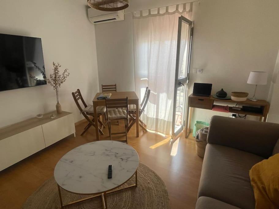 a living room with a couch and a table at Apartamento SALITRE in Fuengirola