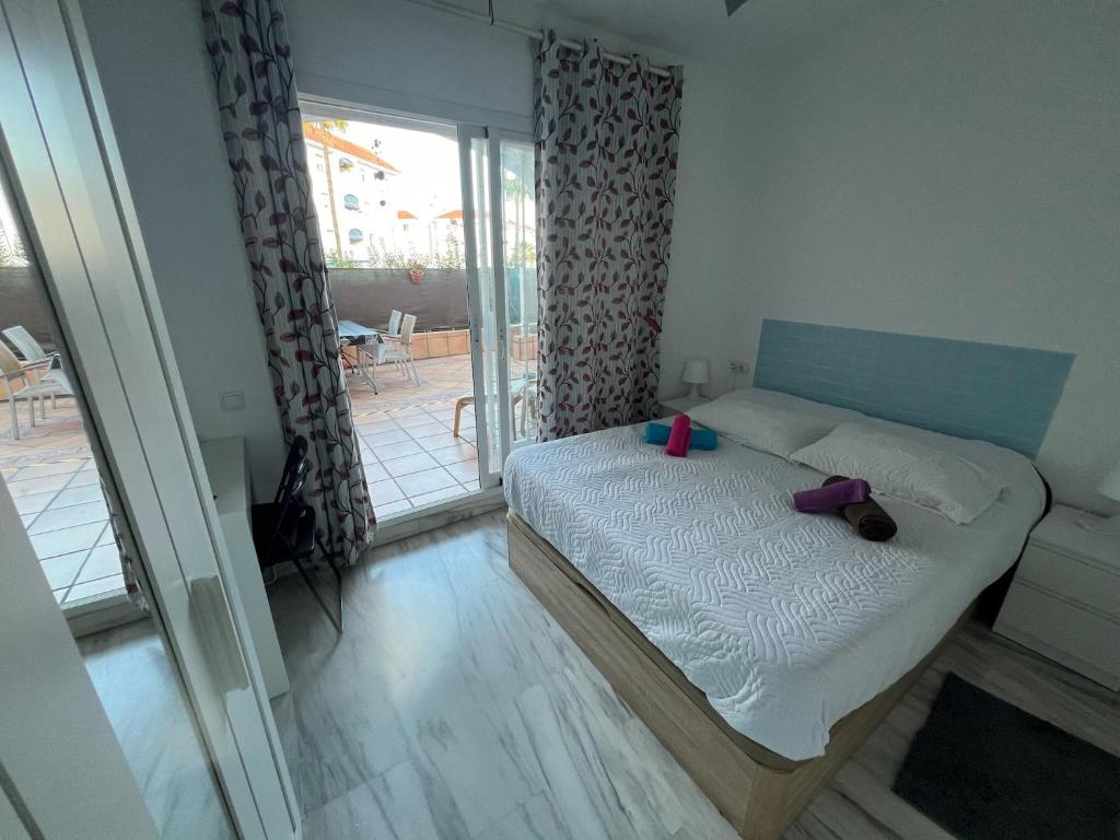 ein kleines Schlafzimmer mit einem Bett und einem Balkon in der Unterkunft Torremolinos habitaciones privada en apartamentos compartidos in Torremolinos