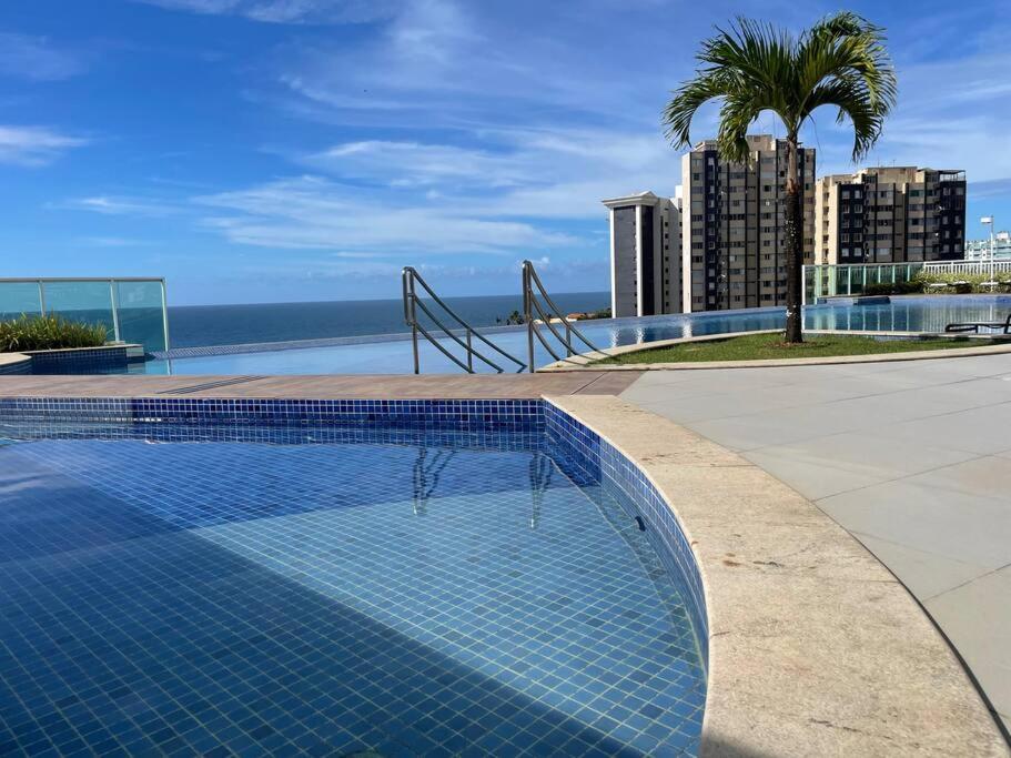 a swimming pool with a view of the ocean at Melhor vista de Salvador, apartamento 59.03m2. in Salvador