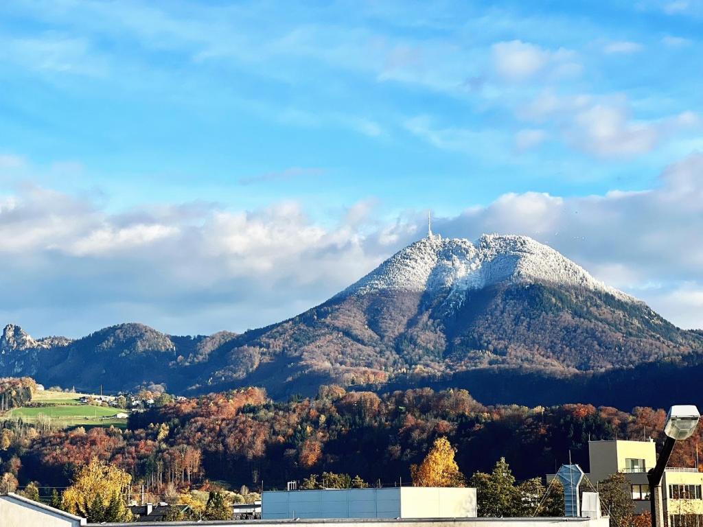a snow covered mountain in the middle of a city at Hotel Genta in Salzburg