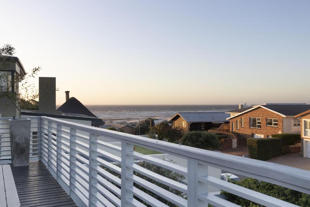 a view of the ocean from the balcony of a house at Korhaan House in Melkbosstrand