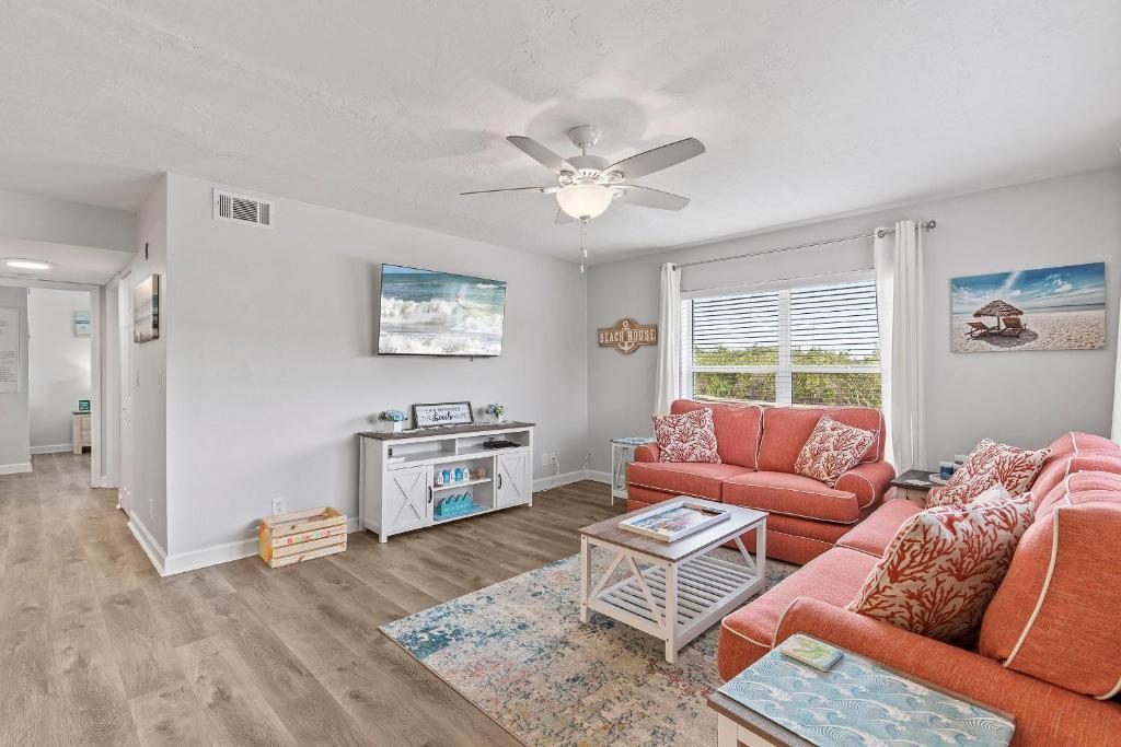 sala de estar con 2 sofás y ventilador de techo en Kiawah Bay 106 en New Smyrna Beach