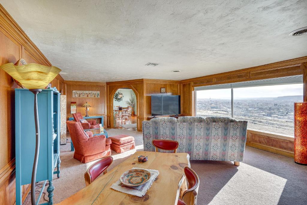 a living room with a table and some chairs at Charming Farmington Home about 16 Mi to Aztec Ruins! in Farmington