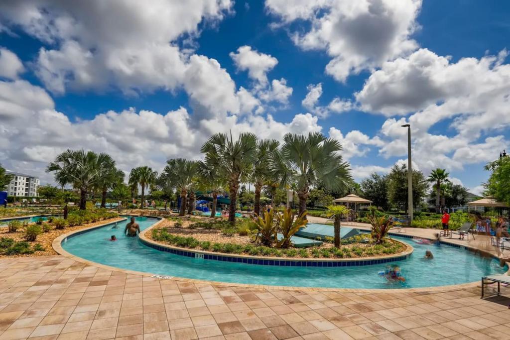 een zwembad in een resort met palmbomen bij Storey Lake Resort Near Disney Universal in Kissimmee
