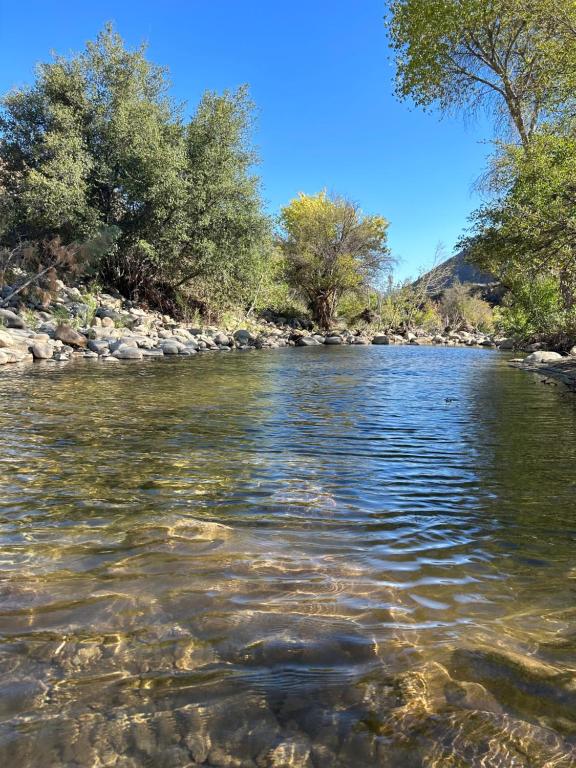 a view of a river with rocks and trees at SoCal Camping in Kernville