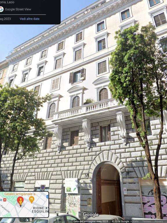 a large white building with an arch in front of it at Bretone XI b&b in Rome