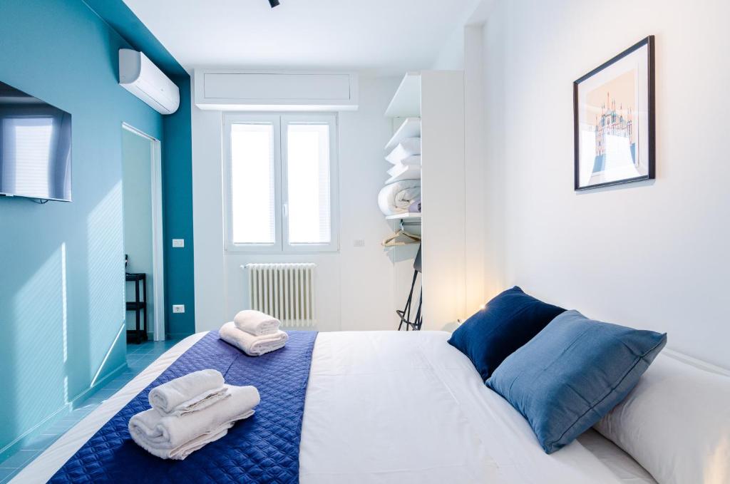 a bedroom with two towels on a bed at SAN SIRO BLUE FLAT in Milan