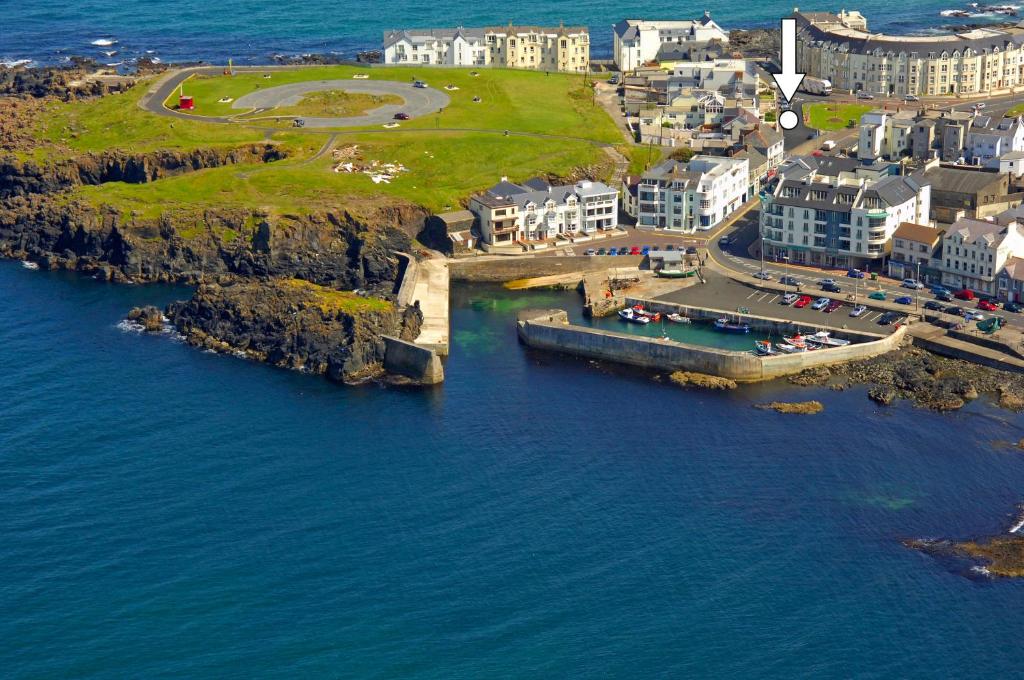 an aerial view of a small island in the ocean at Harbour Views 3 Bed Townhouse with private off street parking and office in Portstewart