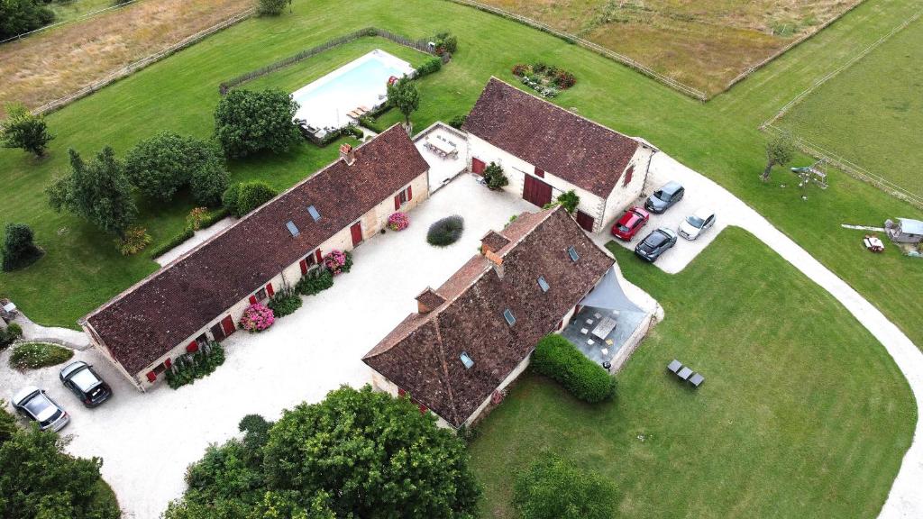 an aerial view of a large house with cars parked outside at La Sautie in Bars