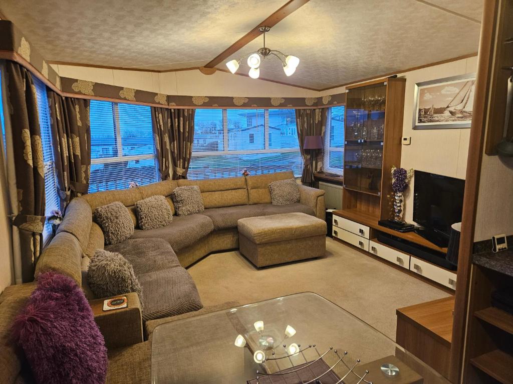 a living room with a couch and a tv at 10 min walk to South Devon beach in Paignton