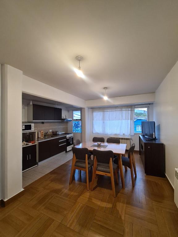 a kitchen and dining room with a table and chairs at Belgrano Ushuaia in Ushuaia