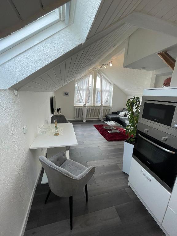 een woonkamer met een witte tafel en een stoel bij Central Ferienwohnung in Bad Saulgau