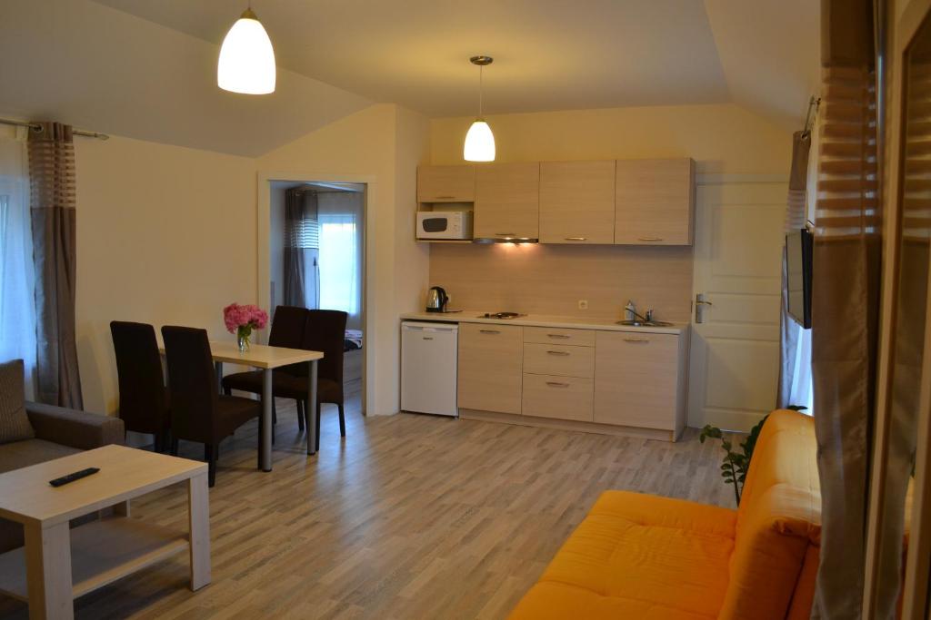 a living room with a kitchen and a dining room at Apartamentai Vilma in Palanga