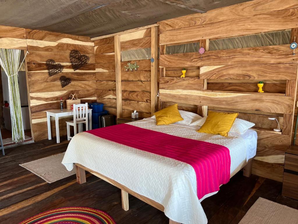 a bedroom with a bed in a log cabin at Cabañas Casa de Agua in Boca del cielo