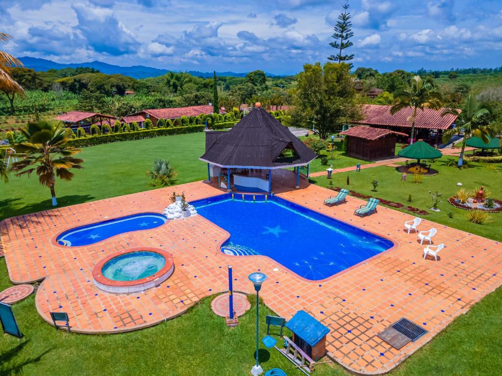 an overhead view of a large swimming pool in a yard at Finca Hotel El Ocaso in Quimbaya