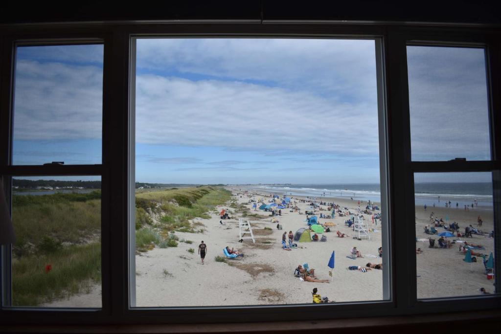 a view of a beach from a window at Norseman Resort on the Beach in Ogunquit