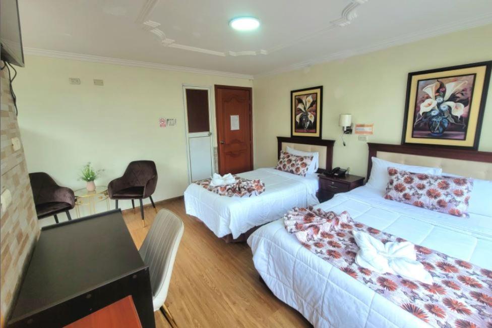 Postel nebo postele na pokoji v ubytování Hotel Virgen del Cisne
