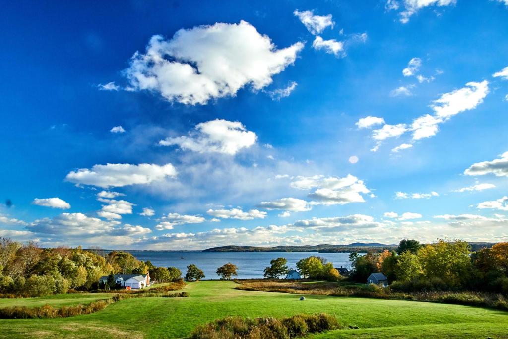 a golf course with a lake in the background at Fireside Inn, Ocean's Edge in Belfast
