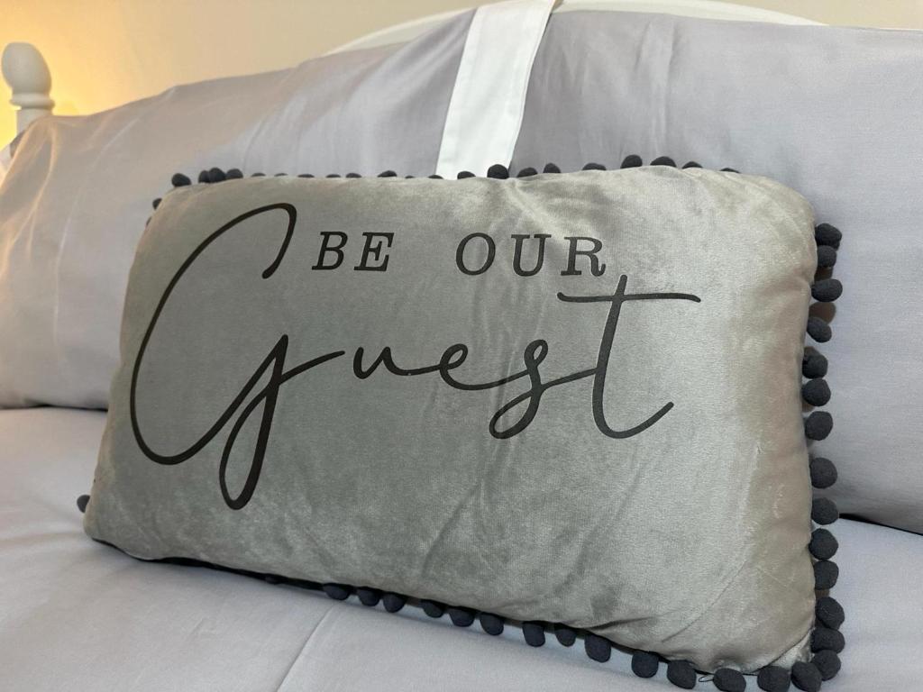 a pillow with the words be our answer on a bed at City Of Chester Award Winning Cottage -Pixie Terrace Chester in Chester