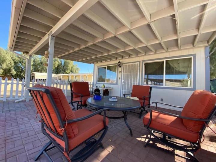 a patio with chairs and a table on a patio at Sun Tiny House B Pahrump in Pahrump