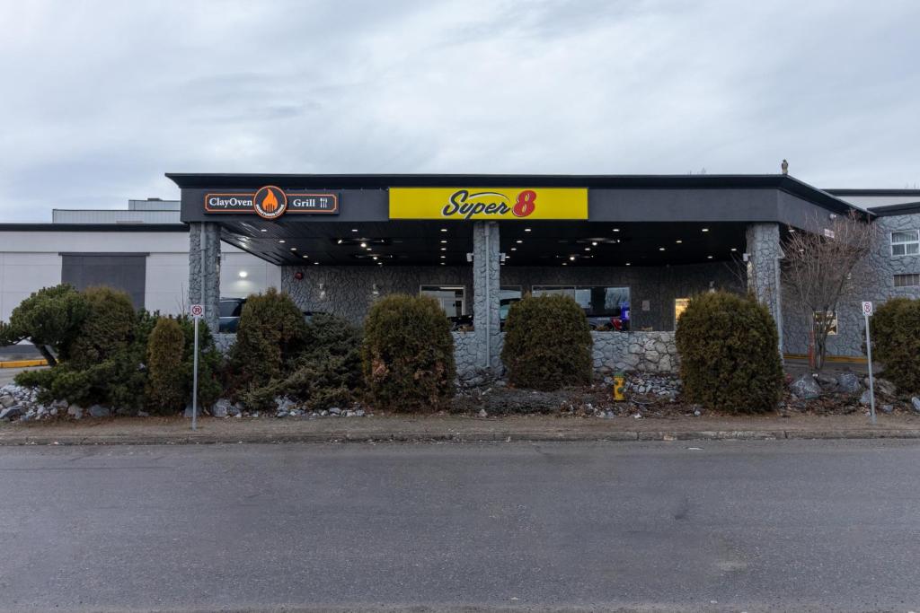 a store with a sign on the front of it at Super 8 by Wyndham Prince George in Prince George