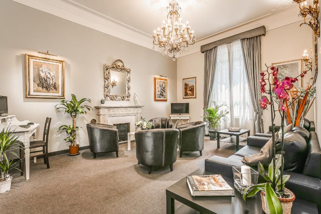 a living room with furniture and a chandelier at Hotel Arno Bellariva in Florence