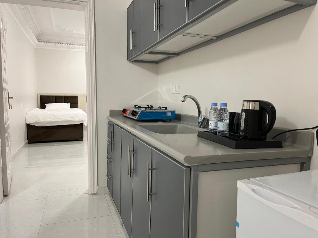 a kitchen with a sink and a counter top at Peacefull night in Al Madinah