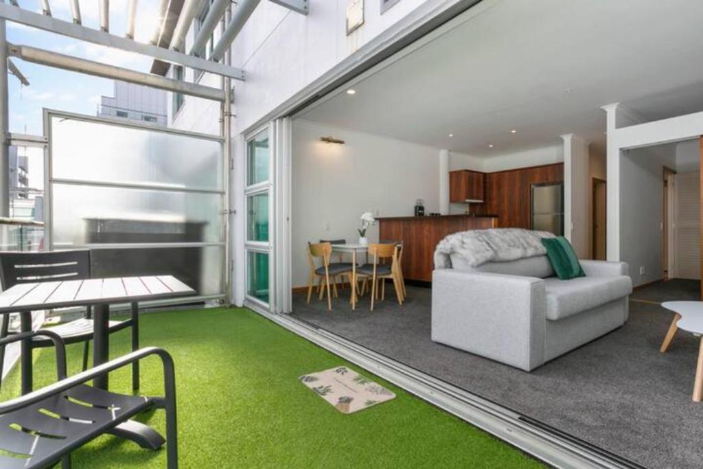 a living room with a bed and a dining room at Luxury Hideaway On Princes Wharf in Auckland
