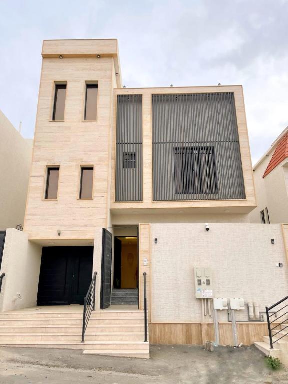 a building with a staircase in front of it at نزل الراشد الفاخرة luxury in Abha