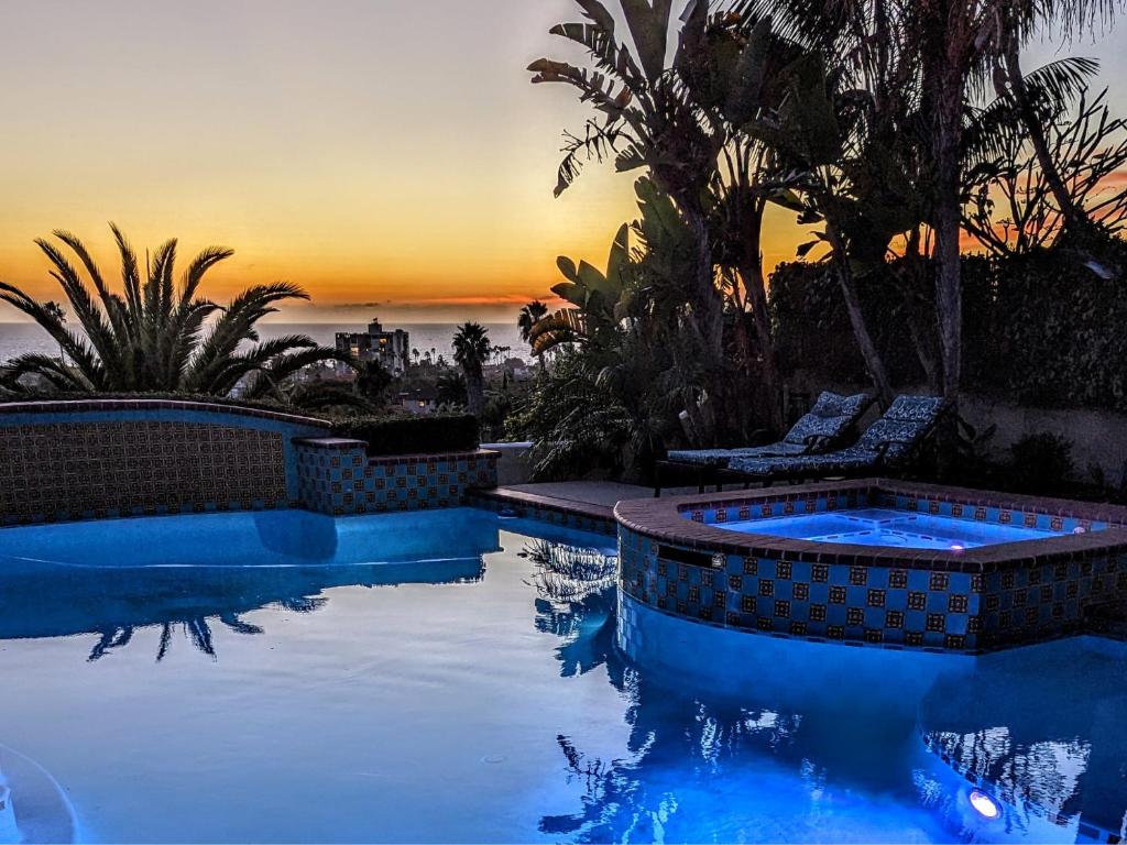 a swimming pool with a sunset in the background at 360 Degree Ocean & City Views With Pool, Spa, Close to the Beach! Pets OK in San Diego