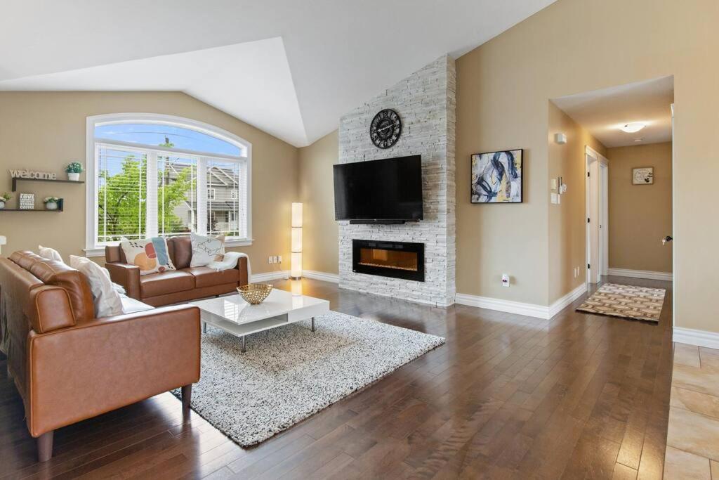 a living room with a couch and a fireplace at Le Cozy Clover in Moncton