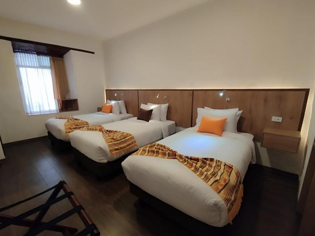 Postel nebo postele na pokoji v ubytování Casona Tobar Hotel