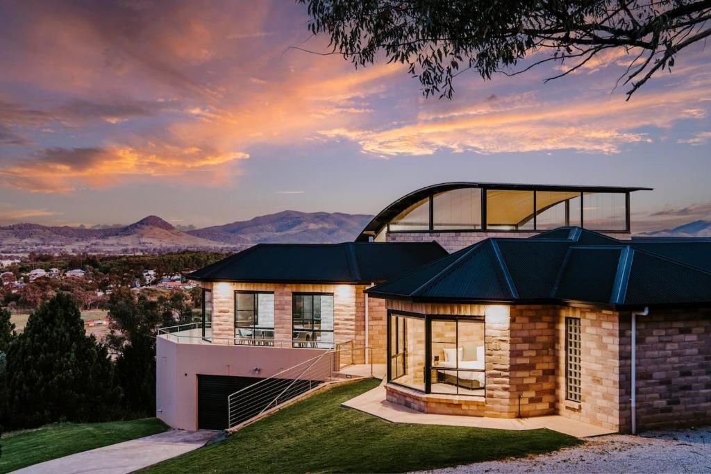 a house on a hill with a view at 'Tyalla Lodge' Unique Luxe Design in the Mountains in Mudgee
