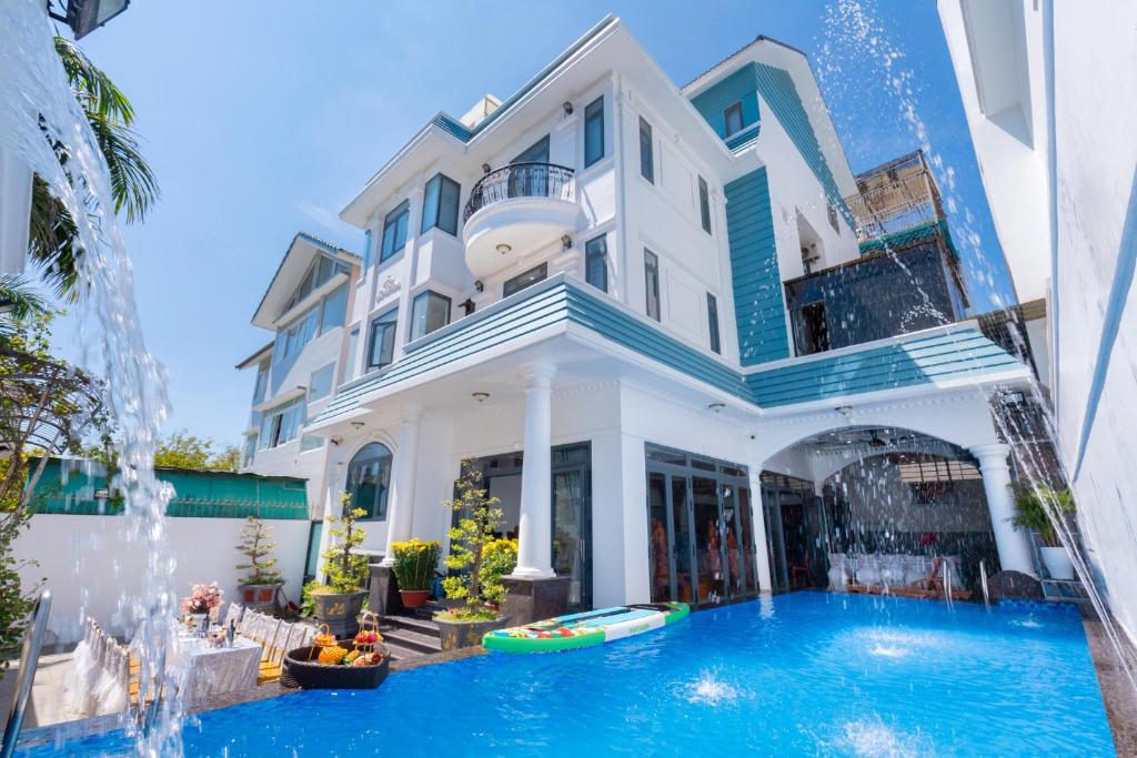 a large building with a swimming pool in front of it at B2.20 Hoàng Sơn in Vung Tau