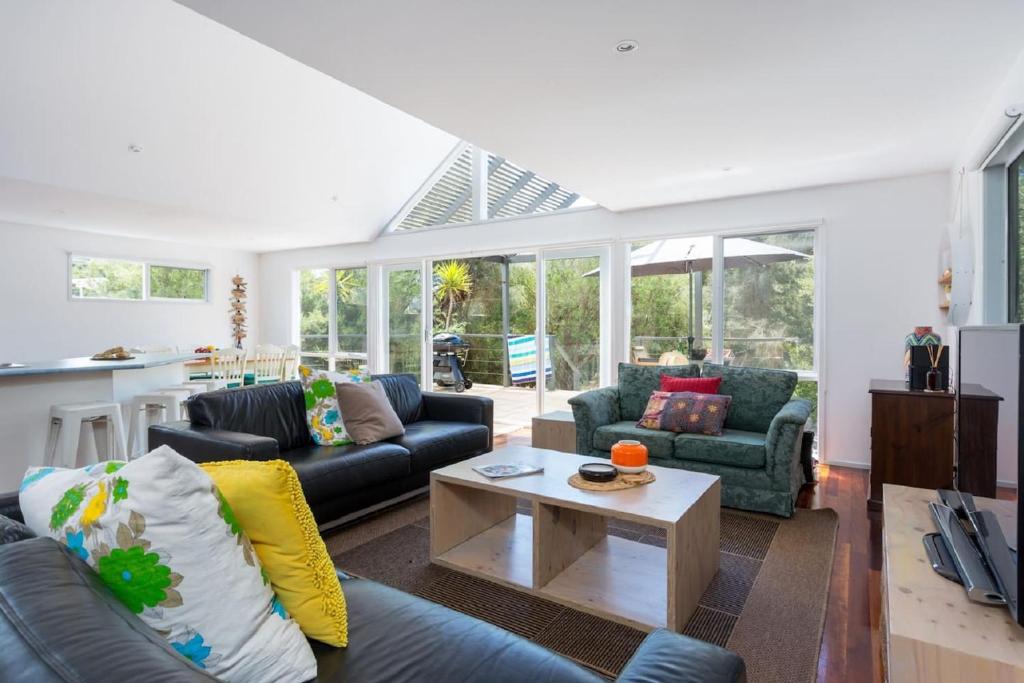 a living room with couches and a table at Stroll to the Sea - Sun-drenched Seaside Lifestyle in Rye