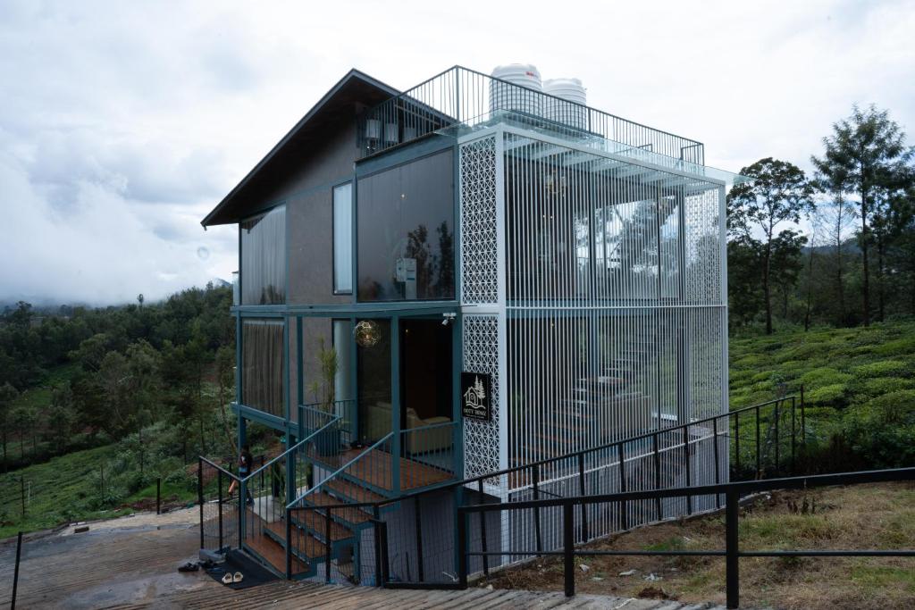 a glass house on top of a hill at OOTYHOMZ LUXURY STAY in Ooty