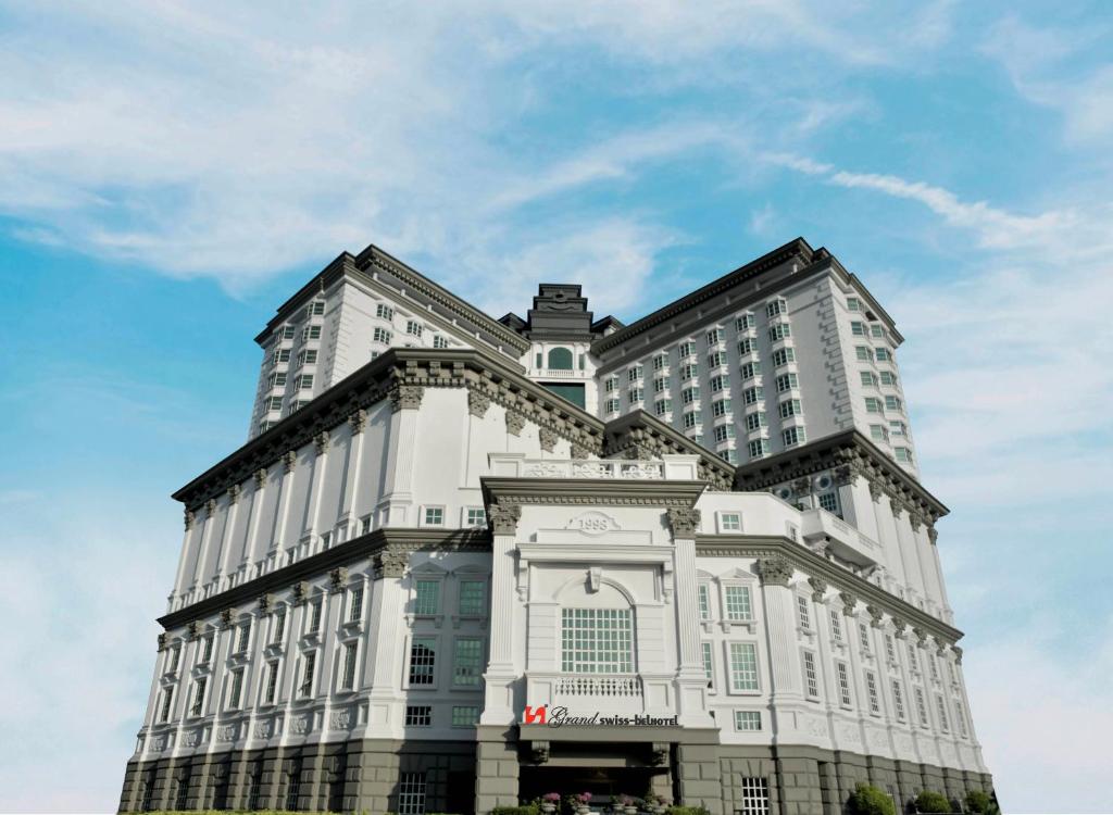 a large white building with a sky in the background at Grand Swiss-Belhotel Melaka - formerly LaCrista Hotel Melaka in Melaka