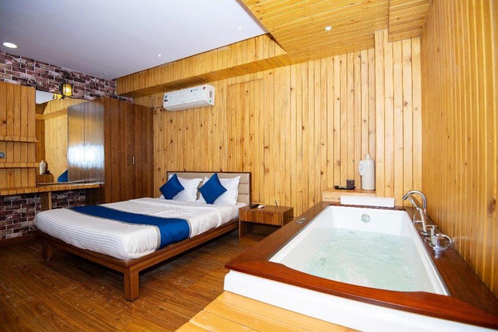 a bedroom with a bed and a bath tub at Hotel Global in Bhatha
