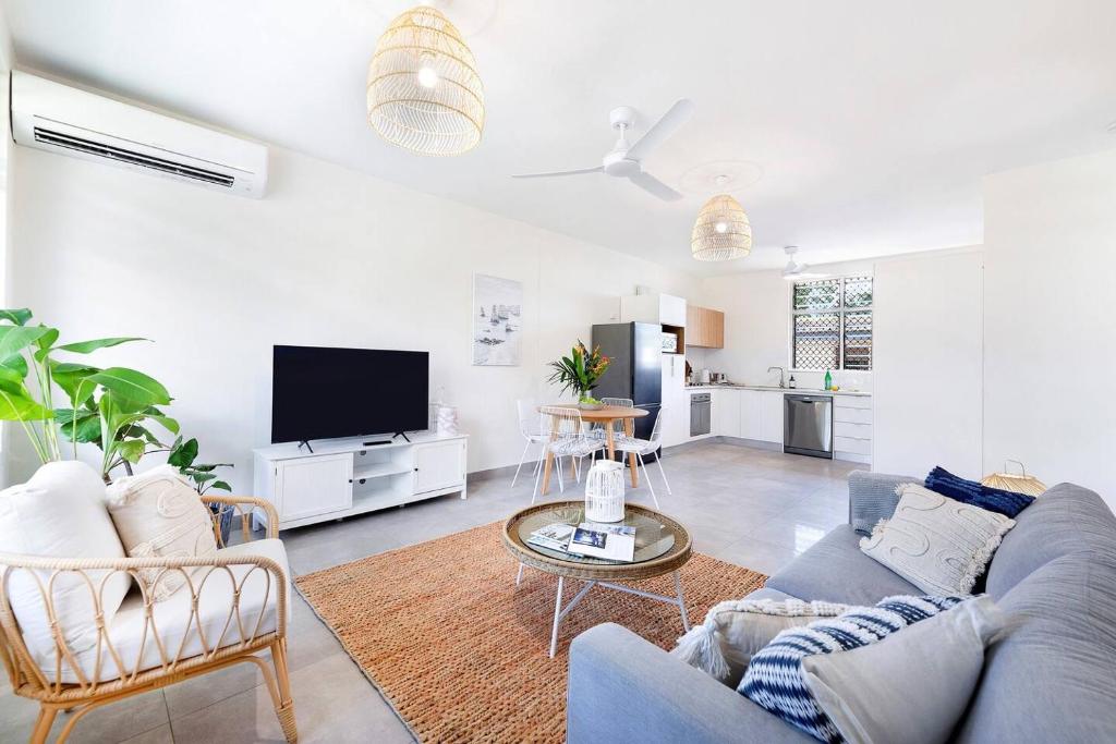 a living room with a couch and a tv at Botanica Trio - Best Nightcliff Residence for Groups in Nightcliff
