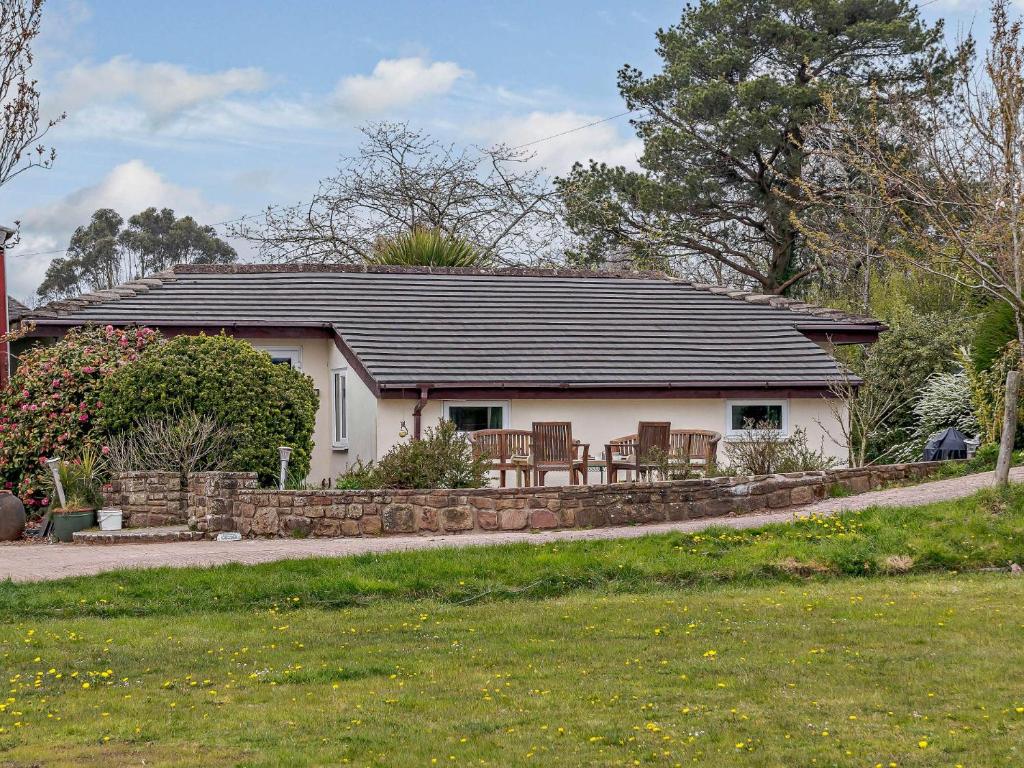 a small white house with a black roof at 3 Bed in Welsh Newton Common 52149 in Welsh Newton Common