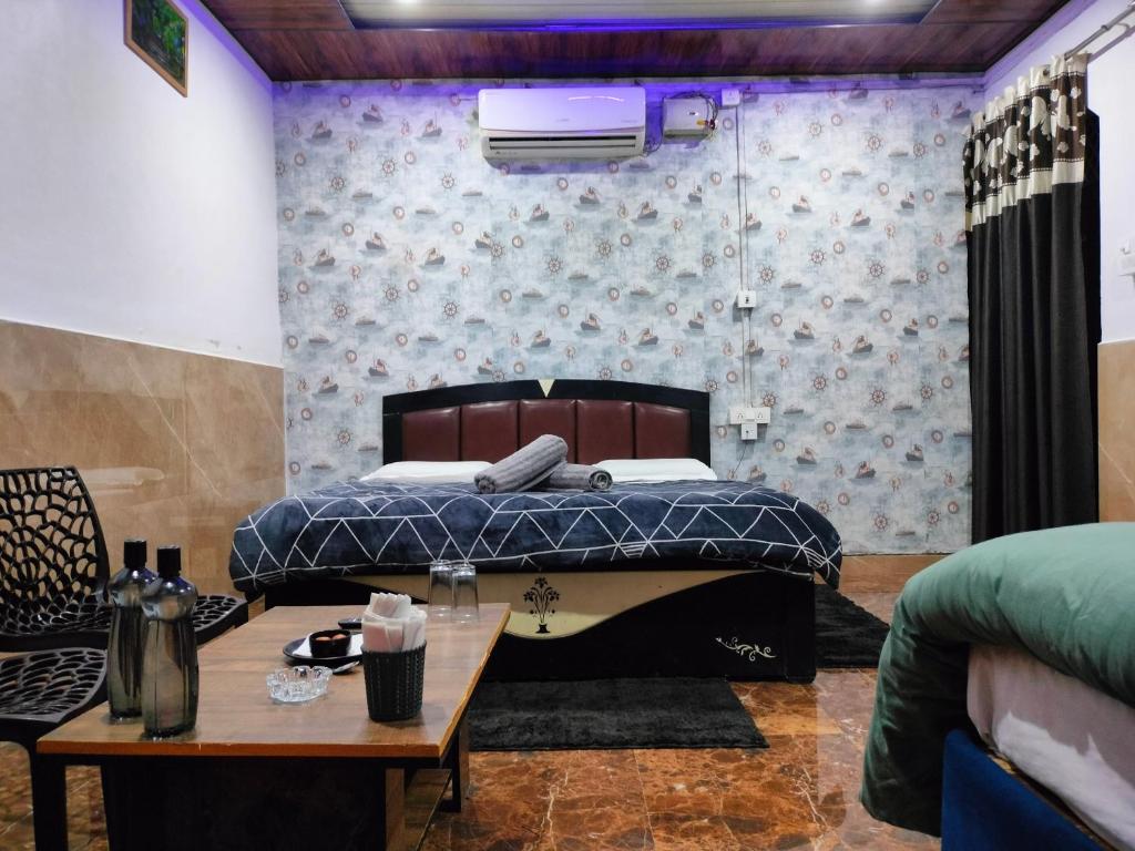a bedroom with a bed and a table at Kishan Home Stay in Mathura