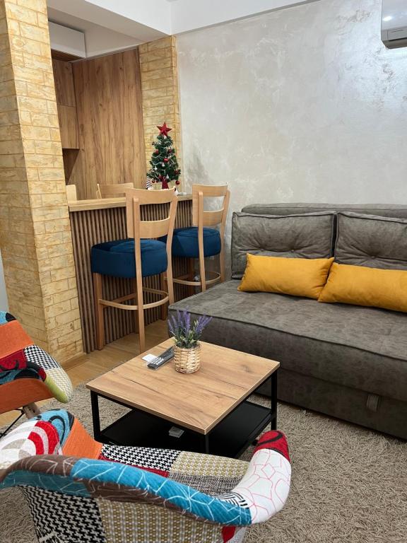 a living room with a couch and a table at Holiday Lux Apartment in Soko Banja