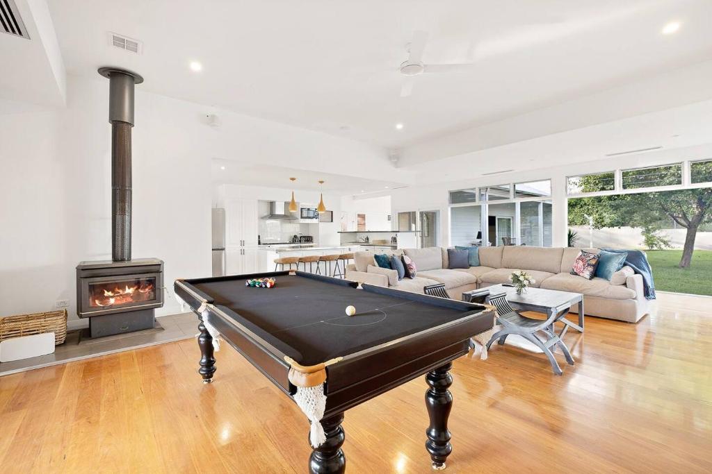 a living room with a pool table and a fireplace at 'Bonnie View' A Magnificently Luxurious Retreat in Mudgee